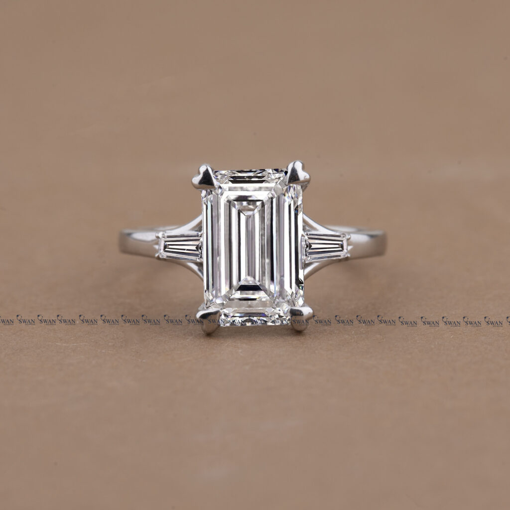 Three Stone Emerald Cut Lab Grown Diamond Engagement Ring With Unique Heart Prong Side Baguette Diamond