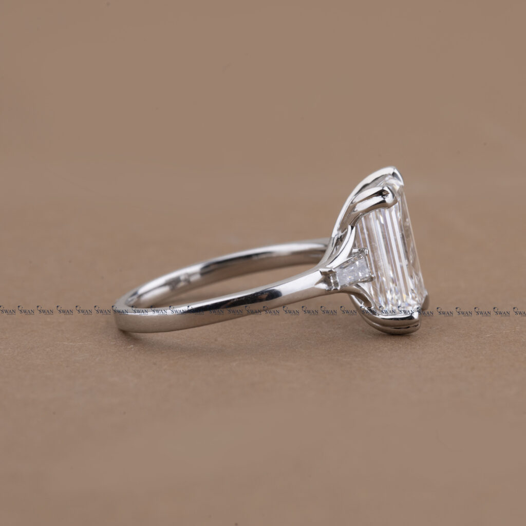 Three Stone Emerald Cut Lab Grown Diamond Engagement Ring With Unique Heart Prong Side Baguette Diamond